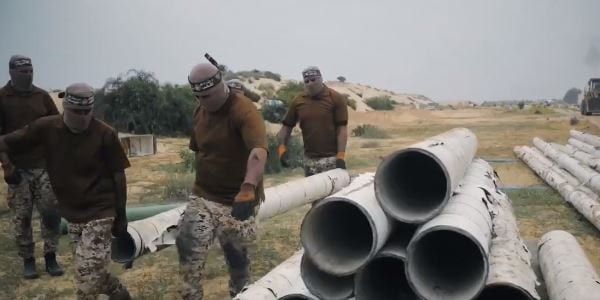 Hamas Terrorists carrying pipe Hamas Terrorists carrying pipe