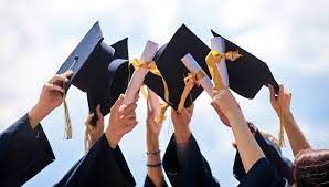 Students raising caps at graduation Students raising caps at graduation