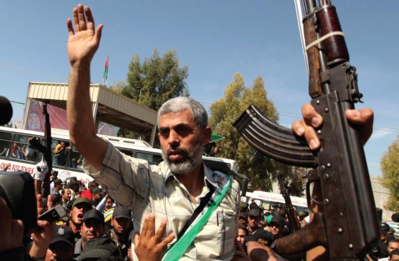 Hamas terrorist with hand raised