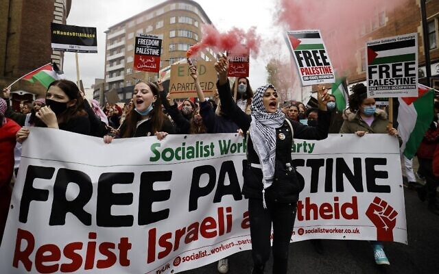 Pro-Palestinian activists and supporters let off smoke flares, wave flags and carry placards during a demonstration